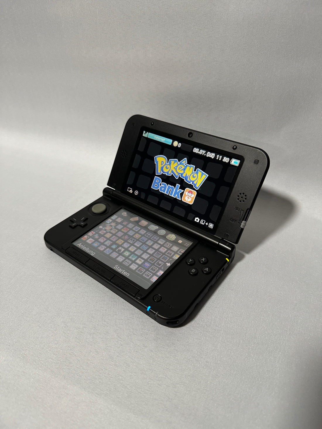 Schwarze ReCollected New Nintendo 3DS XL Konsole mit eingeschaltetem Bildschirm und vorinstallierten Spielen